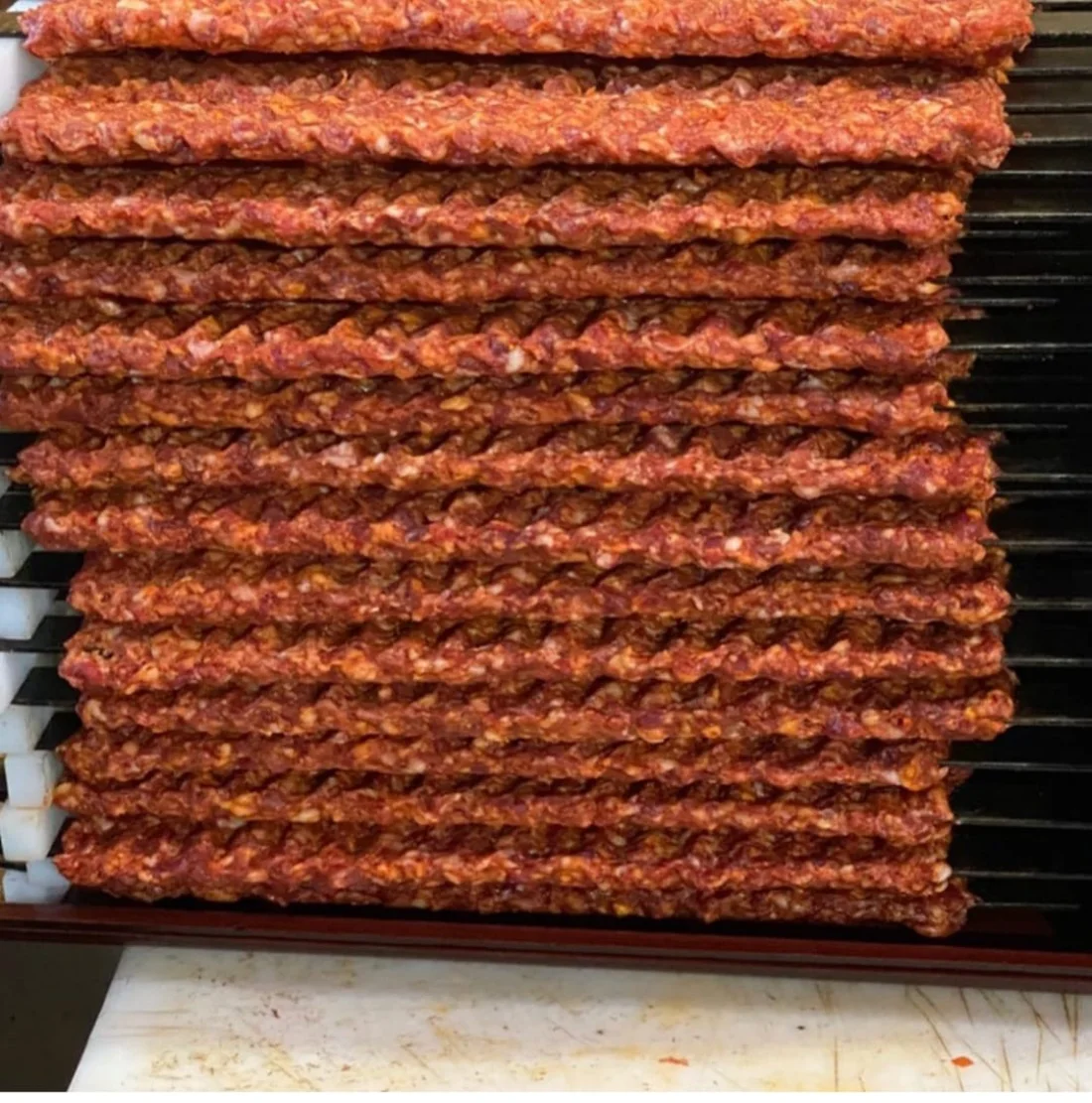 Hand-rolled Adana kebab on the grill
