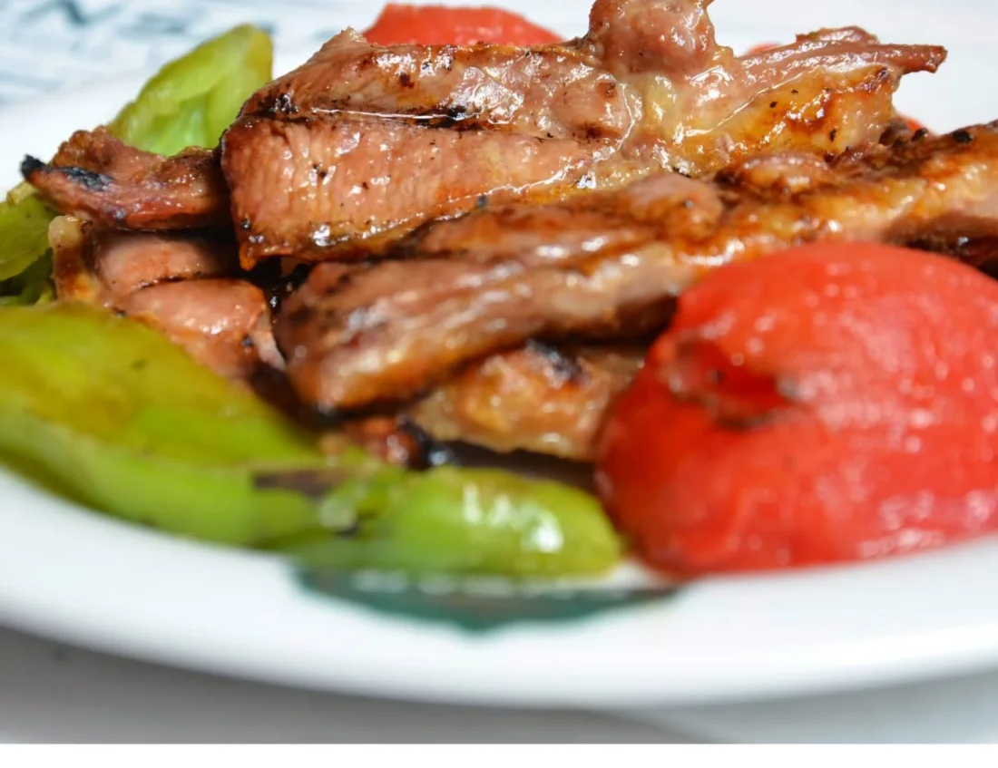 Grilled meat with charred peppers & tomato